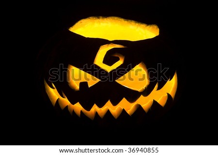 Jack-o\'-lantern, Halloween pumpkin face glowing in the night.