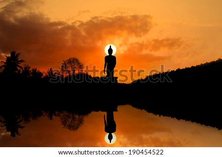 Big Buddha in the evenings. Within the park. Sky sun sets,Silhouette Big Buddha on the water