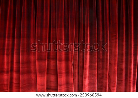 Red closed velvet curtain in a theater