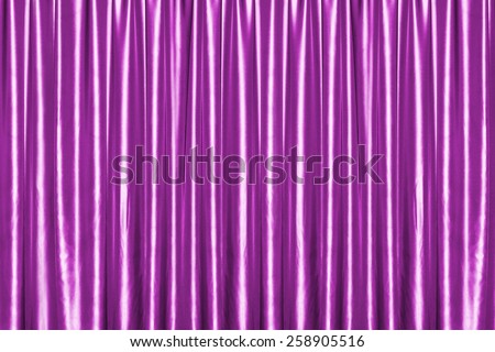 Pink closed satin fabric curtains in theater