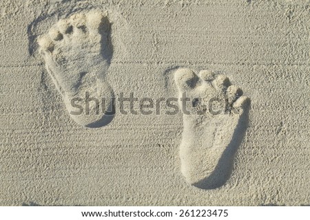 Blurred footprints in the sand on the beach with the sun shines in the morning, a trip to the future success of the business or creative work, walking forward