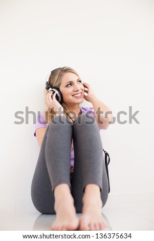 young beautiful woman listen music with headphones isolated