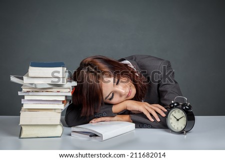 Asian businesswoman get tired reading many books on gray background