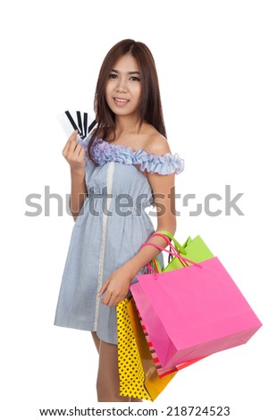 Beautiful Asian woman hold shopping bags show credit cards  isolated on white background