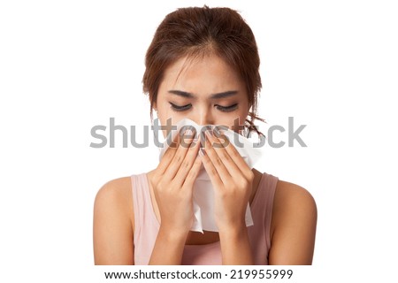 Pretty Asian girl Caught Cold. Sneezing into Tissue.  isolated on white background