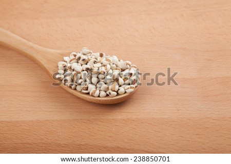 JobÃ?Â¢??s tears with wooden spoon on wood background
