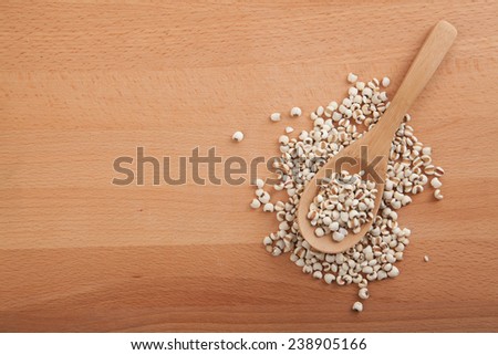 Job\'??s tears with wooden spoon on wood background