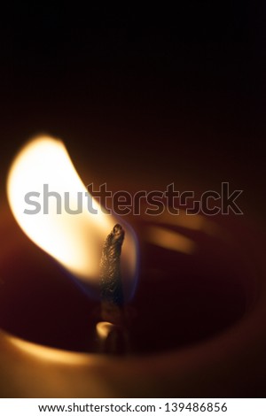 A burning candle being blown out.