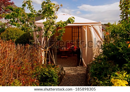 A garden tent, party tent in a summer garden