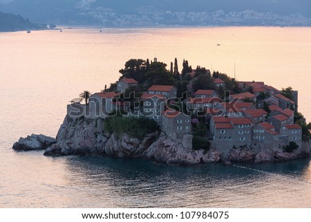 Pink sunset and Sveti Stefan sea islet  with town-hotel view from up (Montenegro, 6 kilometers southeast of Budva)