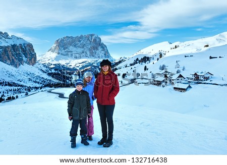 Family on morning winter  mountain background. Gardena Pass  in Dolomites of South Tyrol in northeast Italy.