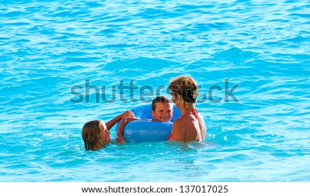 Family (mother with two children) have the water-based recreation (Ionian sea, Lefkada, Greece)