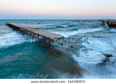 Evening sea storm and ruined pier (Black Sea, Bulgaria).