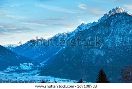 Winter morning mountain country landscape with village in valley (Austria).