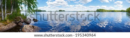 Lake Rutajarvi summer view with reflection of clouds on water surface (Urjala, Finland).