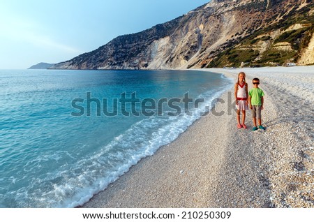 Children on beach. Sea evening view ( Myrtos Beach, Greece, Kefalonia, Ionian Sea).