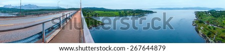 Fjord summer night view from bridge with flowing water (Norway). Panorama.