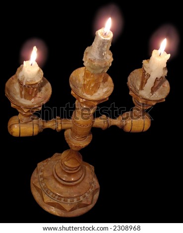 Wood candlestick with 3 shine candles (isolated on black)