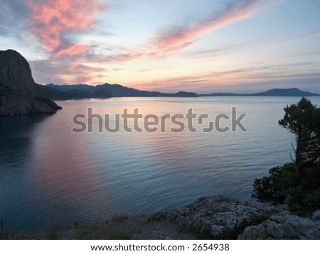 evening sea landscape with red clouds and bay
