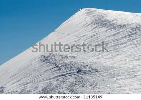 Lofty snow covered mount top on blue sky background (Ukraine, Carpathian Mt\'s, Svydovets Ridge, Blyznycja Mount)