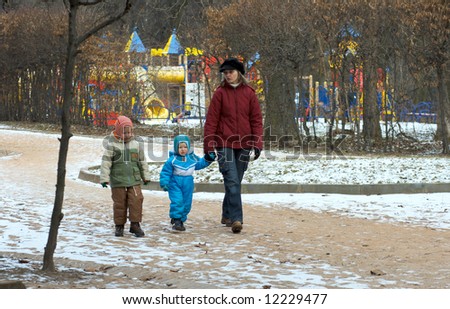 Family in winter city park  return home