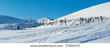 Morning mountain panorama with long blue daybreak shadows, ski tracks and ski hoist ropeway (Drahobrat Ski Resort, Yasenja village, Zacarpatsjka Region, Ukraine). Five shots stitch image.