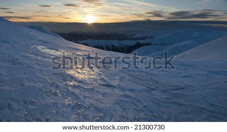 Beautiful mountain sunset landscape with sun way on ice-coated mountainside (Ukraine, Carpathian Mt's, Svydovets Range). Four shots stitch image.