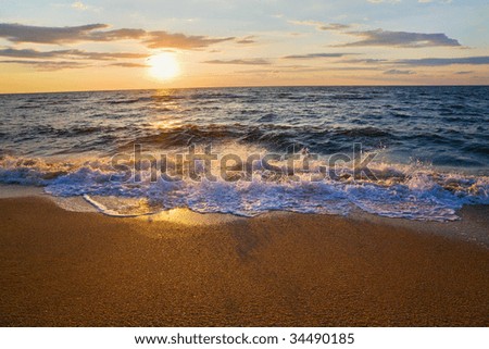 Sea  sunset surf great wave break on sandy coastline (and splashes shadows)