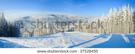 Winter mountain landscape with ski lift and skiing slope. Bukovel ski resort, Ukraine. Three shots stitch image.