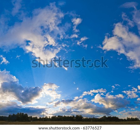 Evening blue sky panorama with clouds over plain and camp on forest Four shots stitch image.