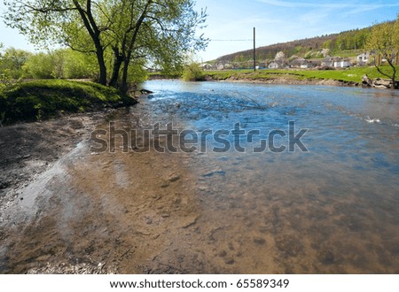 Spring country landscape with village and river ( Lvov Oblast, Ukraine) .