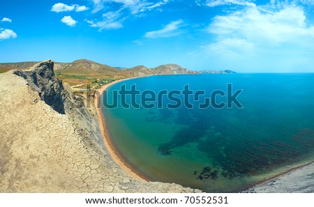 Summer rocky coastline and camping on sandy beach (Tihaja Bay, Crimea, Ukraine ). All peoples and cars is unrecognizable. Three shots stitch image.