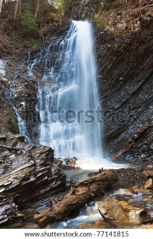 High mountain waterfall in wild Carpathian forest (Guk Waterfall, Ivano-Frankivsk Region,  Ukraine).