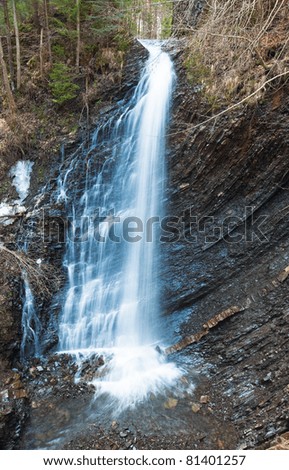 High mountain waterfall in wild Carpathian forest (Guk Waterfall, Ivano-Frankivsk Region,  Ukraine).