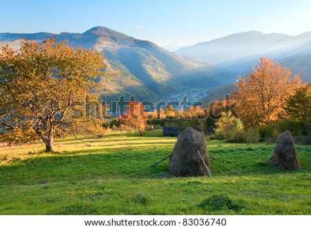 Autumn misty evening mountain hill with stack of hay  (Rahiv town outskirts, Carpathian Mt\'s, Ukraine).
