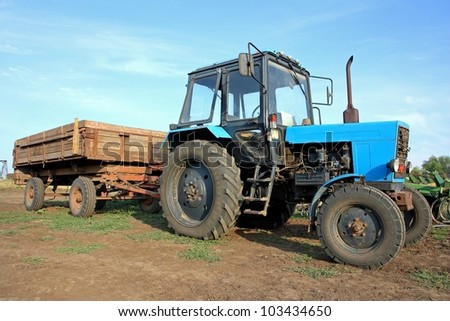 Color photo of an old tractor with a trailer
