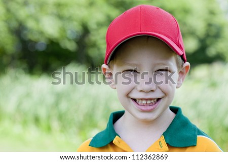 Cute boy with big smile outdoors portrait
