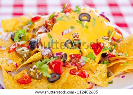 Plate of fresh nachos with a spicy jalapeno cheese sauce