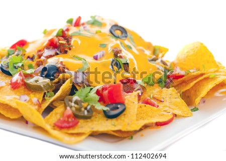 Plate of fresh nachos with a spicy jalapeno cheese sauce