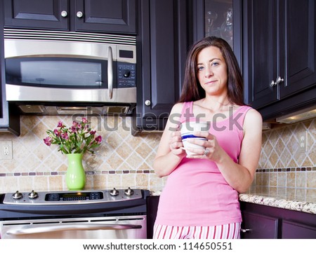 Attractive woman wearing pajamas drinking coffee