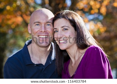 Pretty woman and husband fall portrait outdoors
