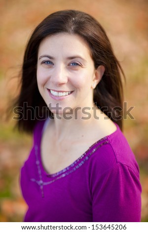 Pretty woman outdoors portrait with fall colors background