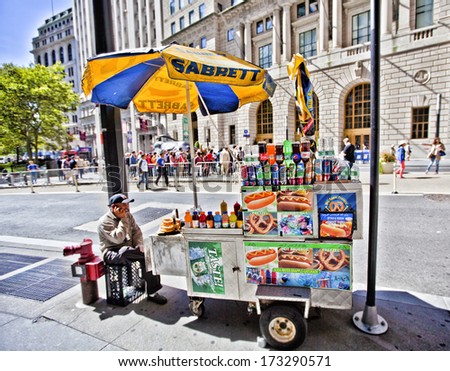 NEW YORK CITY SEPT 22 Street food vendors in New York City with tourists at the famous Charging Bull September 22nd 2013 in Manhattan New York City NEW YORK CITY SEPT 22 Street food vendors in New York City with tourists at the famous Charging Bull September 22nd 2013 in Manhattan New York City