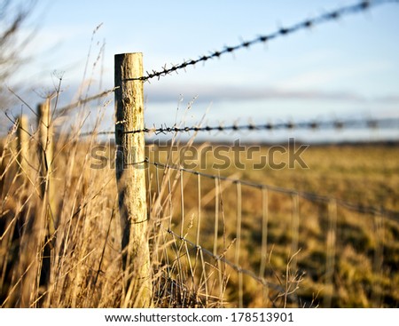 Wooden barbed wire fence in the countryside