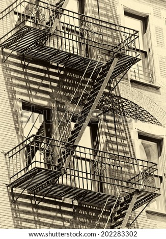 Old urban New York building with fire escape in new york , monotone