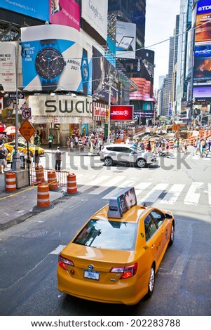 NEW YORK, USA - JUNE 28th 2014: Famous New York Times Square with yellow taxi cab and crowds of visitors