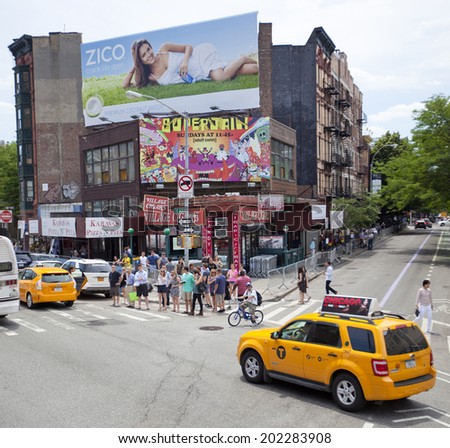 NEW YORK, USA - JUNE 28th 2014: Greenwich village the fashionable New York city district with people and yellow cabs