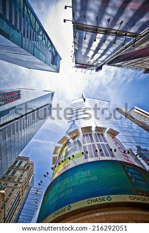 NEW YORK CITY - JUNE 28, 2014: A vertical view of Times Square which is a busy tourist intersection of neon art and commerce and is an iconic street of New York City.