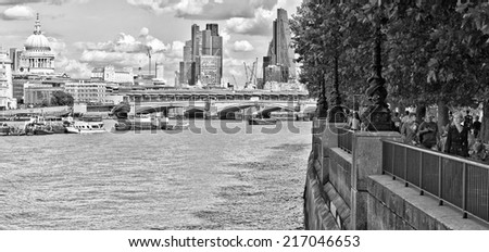LONDON, UK - AUG 22, 2014: Panoramic view of London\'s River Thames and South Bank promenade in black and white
