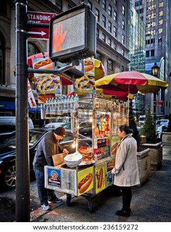 NEW YORK, USA - NOVEMBER 13th, 2014: Food cart vendors can be found all over the streets of midtown Manhattan providing hot dogs and snacks